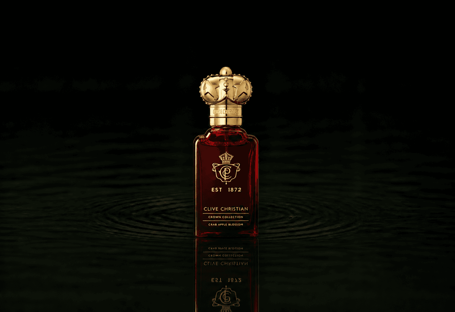 Clive Christian Crown Crab Apple Blossom fragrance bottle floating above dark water