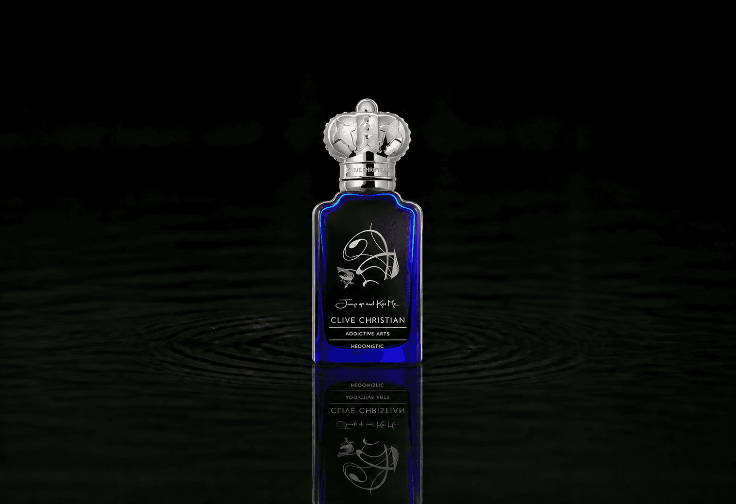 Clive Christian Jump Up and Kiss Me Hedonistic fragrance bottle floating above dark water