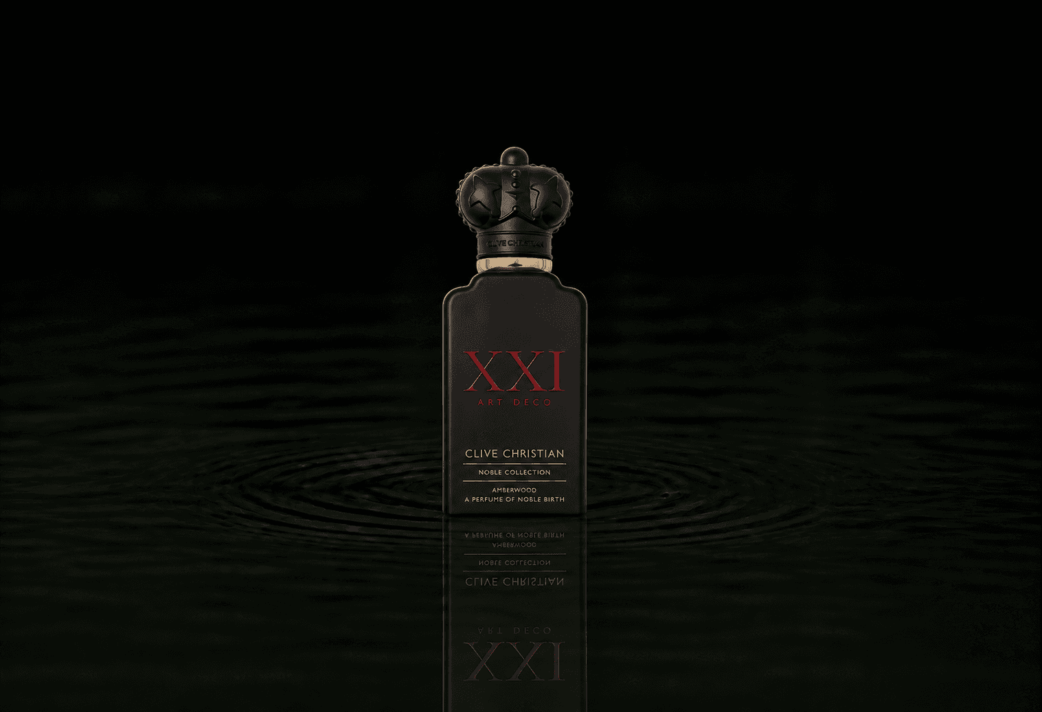 Clive Christian Noble Xxi Art Deco Amberwood fragrance bottle floating above dark water