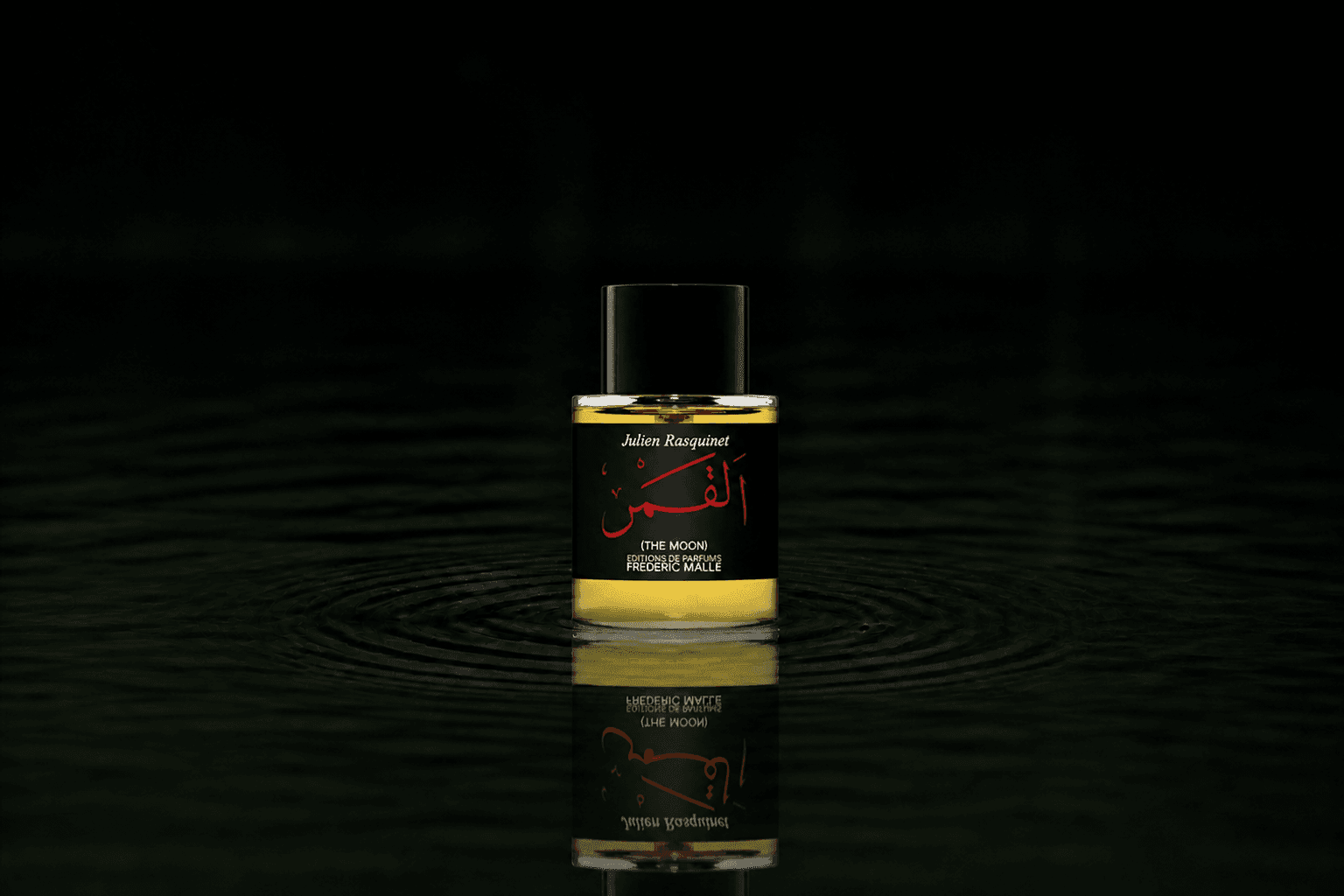 Editions de Parfums Frederic Malle The Moon fragrance bottle floating above dark water