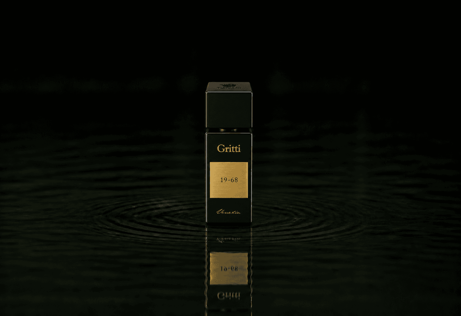 Gritti 19-68 fragrance bottle floating above dark water