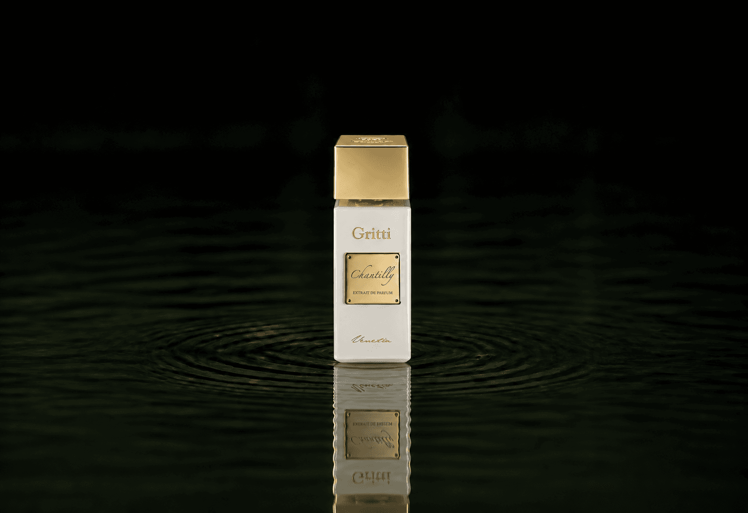 Gritti Chantilly Extrait fragrance bottle floating above dark water