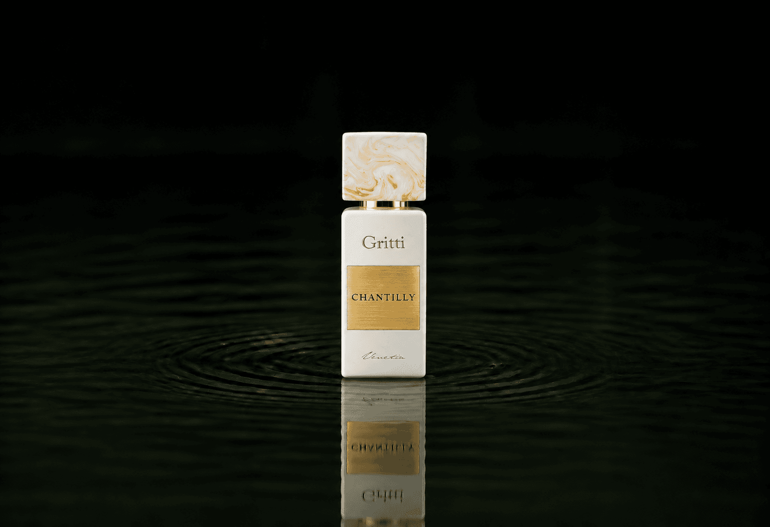 Gritti Chantilly fragrance bottle floating above dark water
