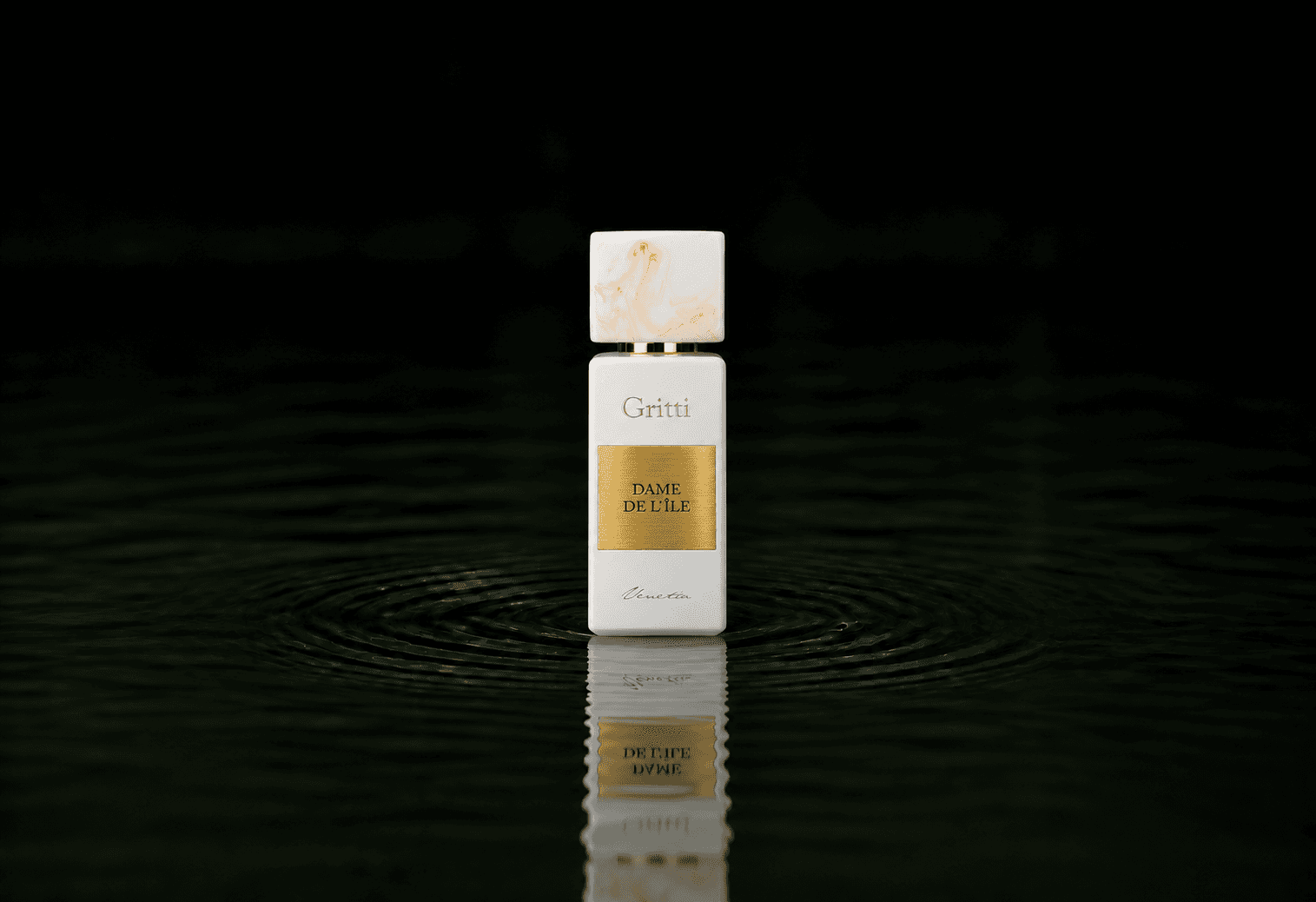 Gritti Dame De L'ile fragrance bottle floating above dark water