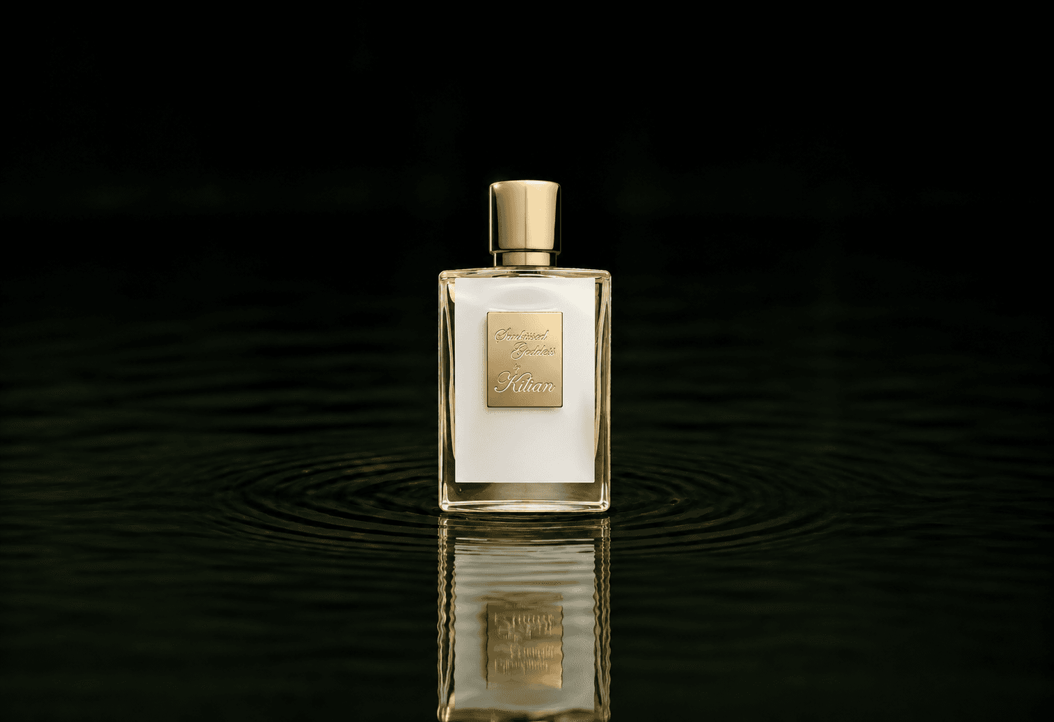 Kilian Sunkissed Goddess fragrance bottle floating above dark water