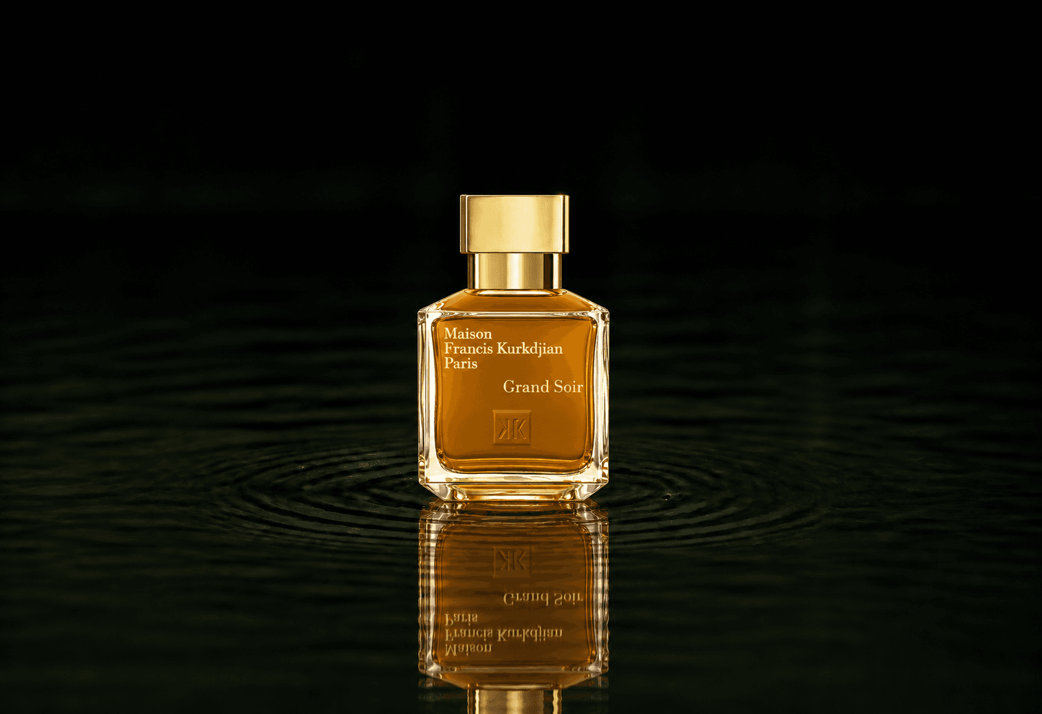 Maison Francis Kurkdjian Grand Soir fragrance bottle floating above dark water